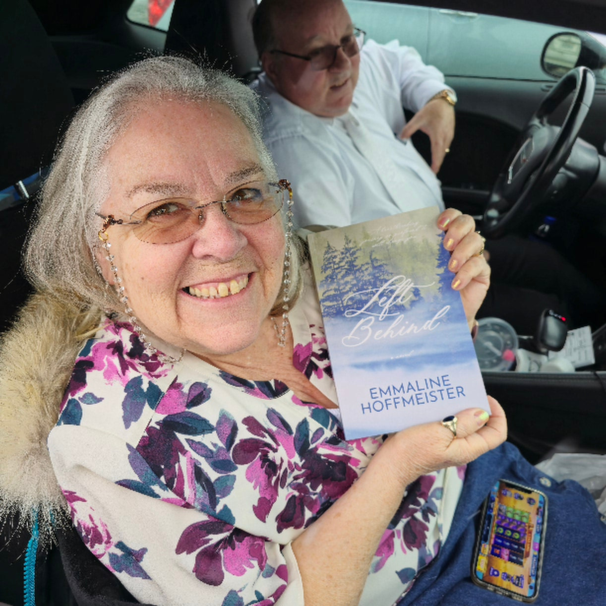 Reader Dena Billman holding a copy of Left Behind, a Christian novel