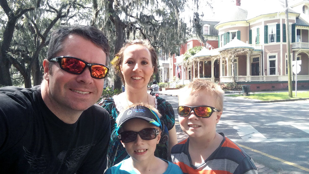 Rhett, Emmaline, Aldrich, and Darce Hoffmeister in front of a row of historic homes in Savannah, Georgia.